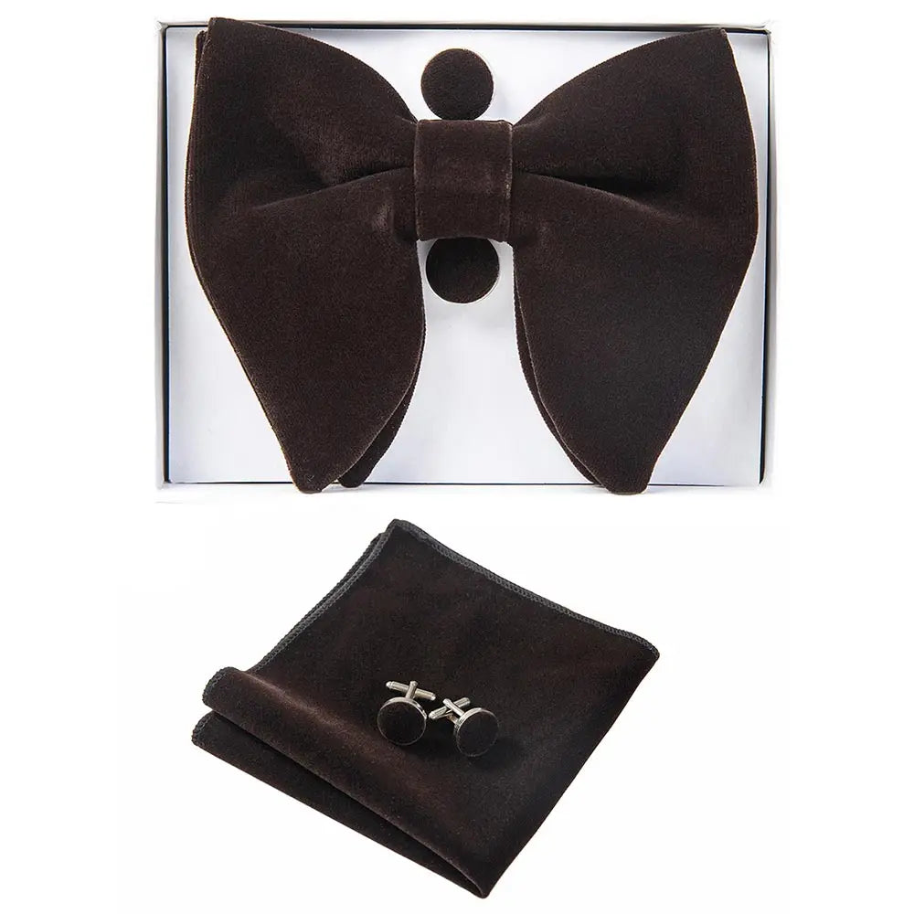Brown bow tie, pocket square, and cufflinks set in a box on a white background