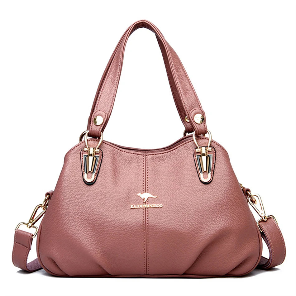Pink leather tote bag with gold-tone hardware, a shoulder strap, and a handheld top.