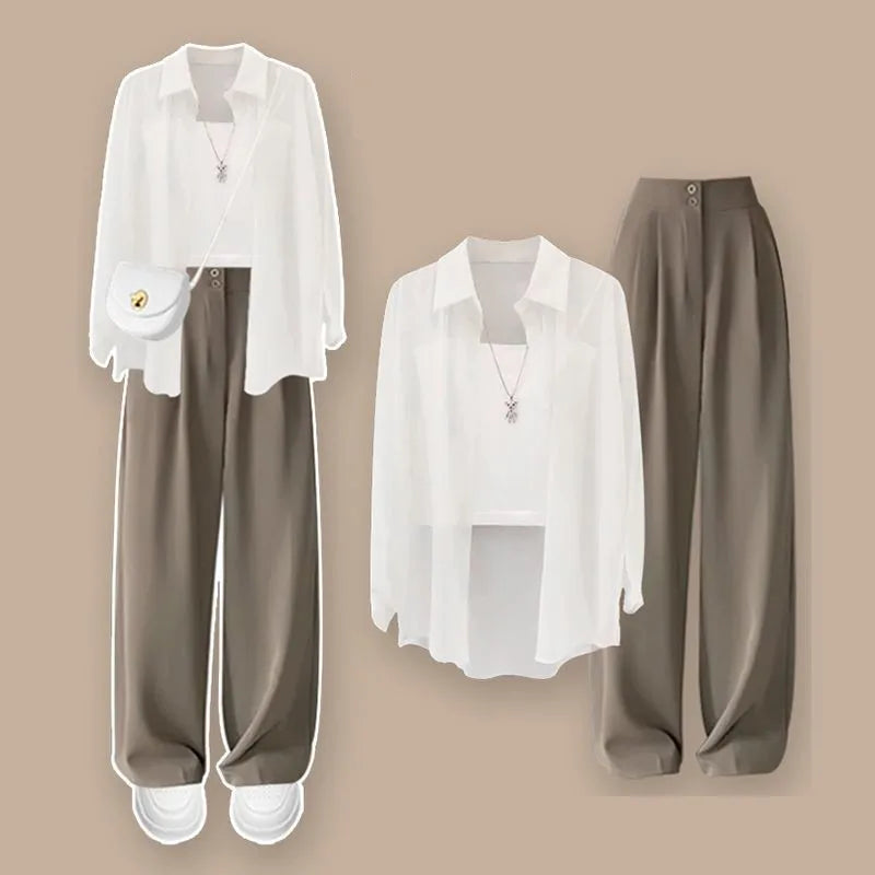 White blouse with brown pants on a beige background. Women’s 3-piece French style set: chiffon cardigan, sling shirt, high-waist wide leg pants. Chic, lightweight and sun-protective fashion for spring/summer.