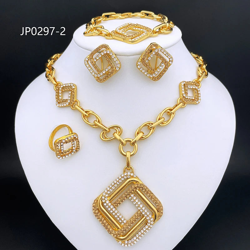 Gold jewelry set displayed on a white neck bust, including a necklace with a large square pendant, matching bracelet, earrings, and ring, all featuring gold-tone metal and clear rhinestone detailing. The text 'JP0297-2' appears in the upper left on a black background.