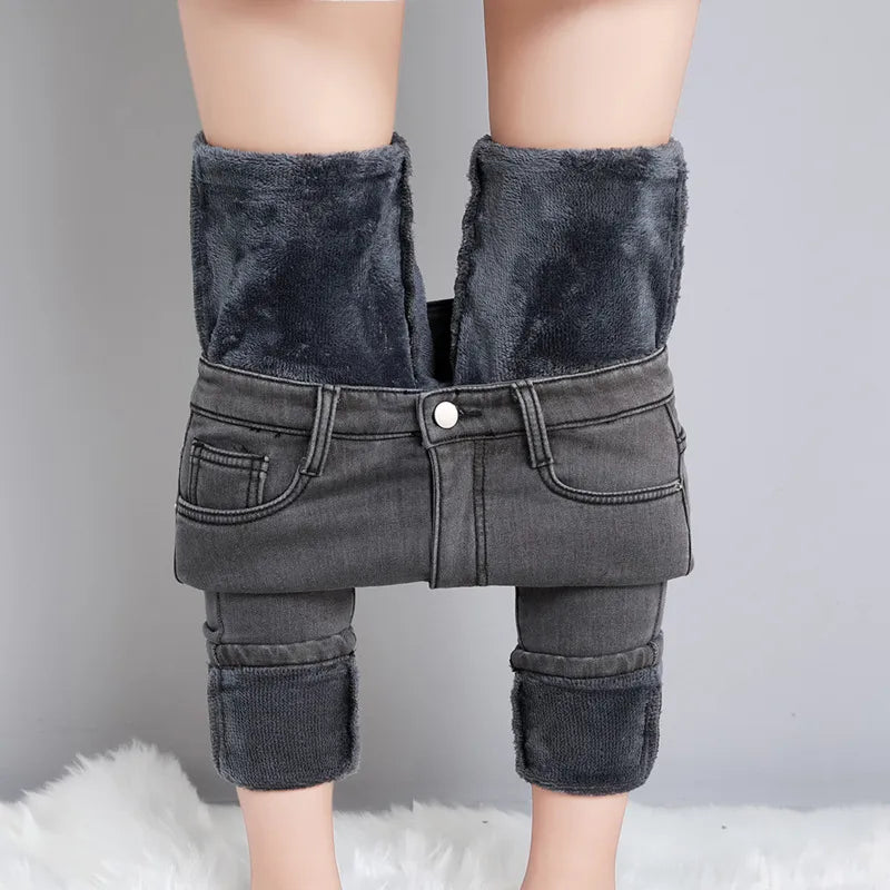 Gray flat lay of warm fleece-lined skinny jeans in dark wash denim, front view
