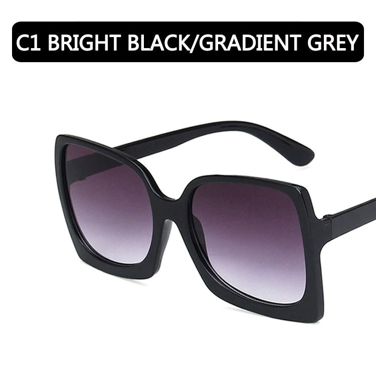 Black sunglasses with gradient gray lenses on a white background. Big frame oversized rectangle sunglasses with gradient UV400 mirrored lenses UK.