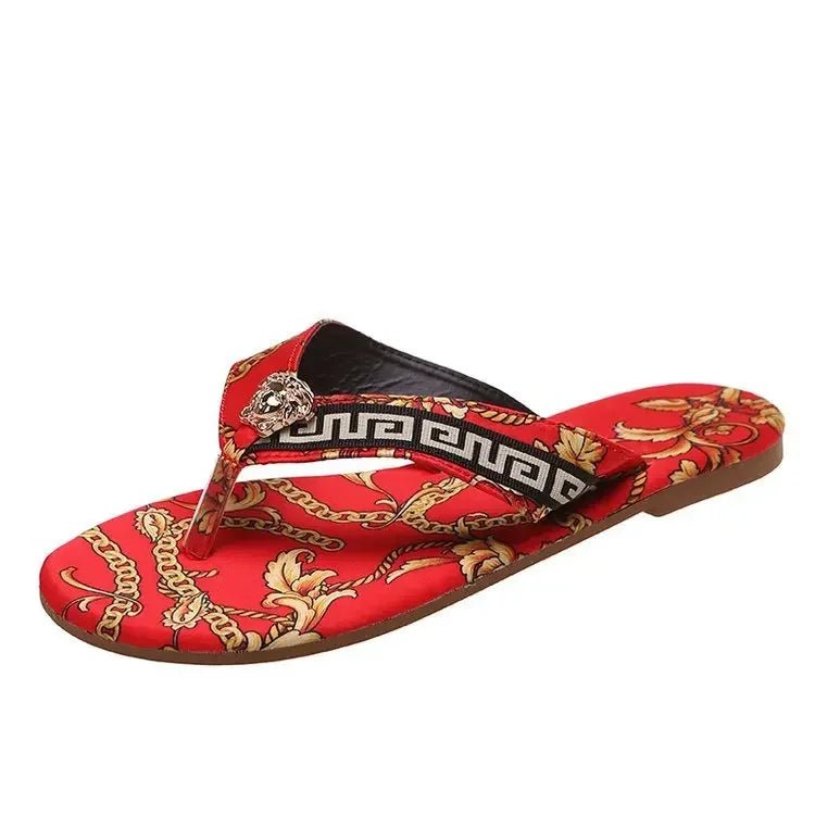 Red sandal with gold chain design and black strap on a white background. Chic women’s printed flip flops UK with flat non-slip sole, lightweight and durable.