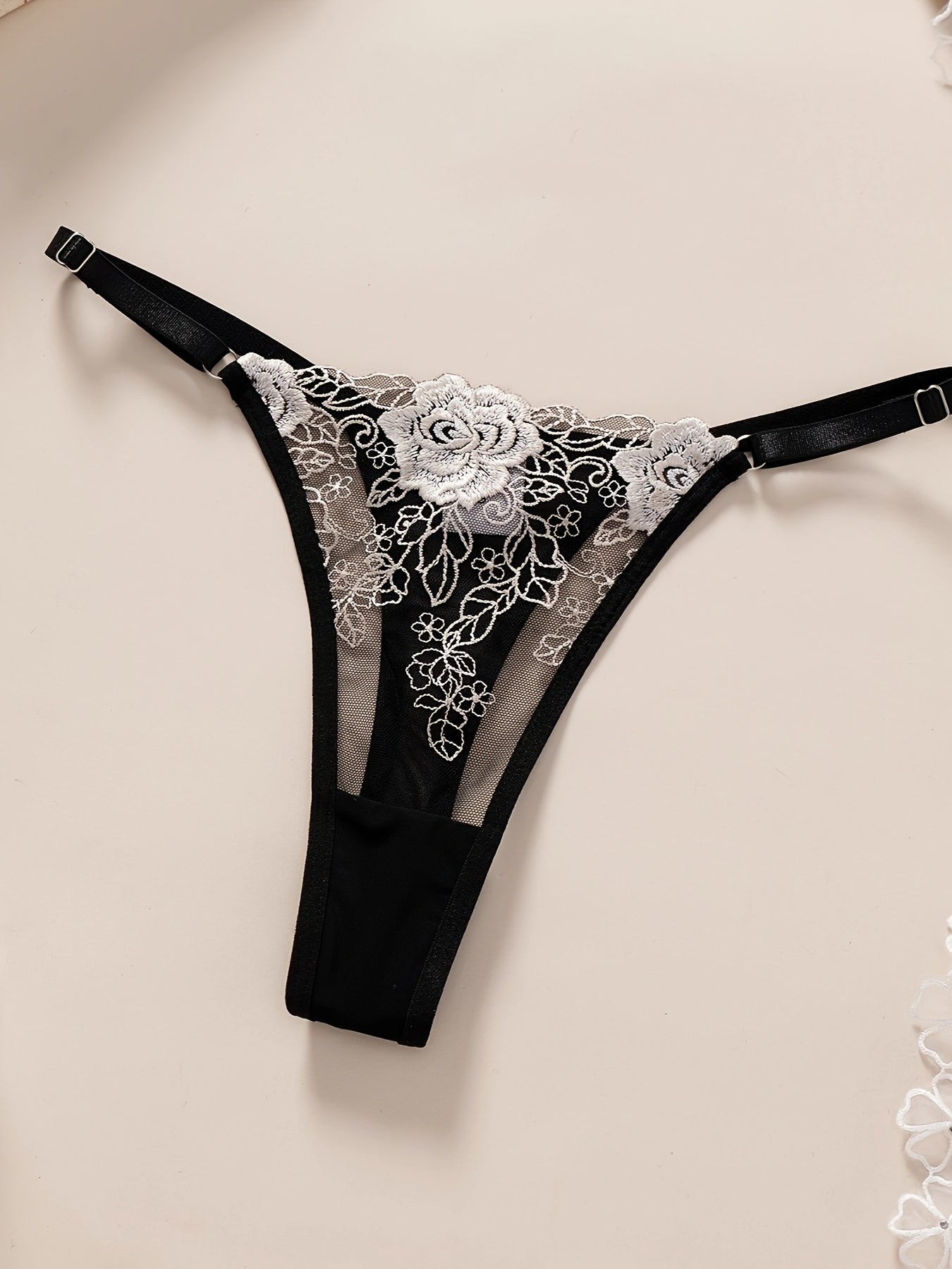 Elegant Black & White Floral Embroidered Lingerie Set featuring a comfortable gauze double-layer bra with a non-padded design and matching thong. Made from polyester and elastane blend, hand washable, and sexy semi-sheer adult ensemble. Perfect for any occasion. Embrace ftf fashion and mode ftf.