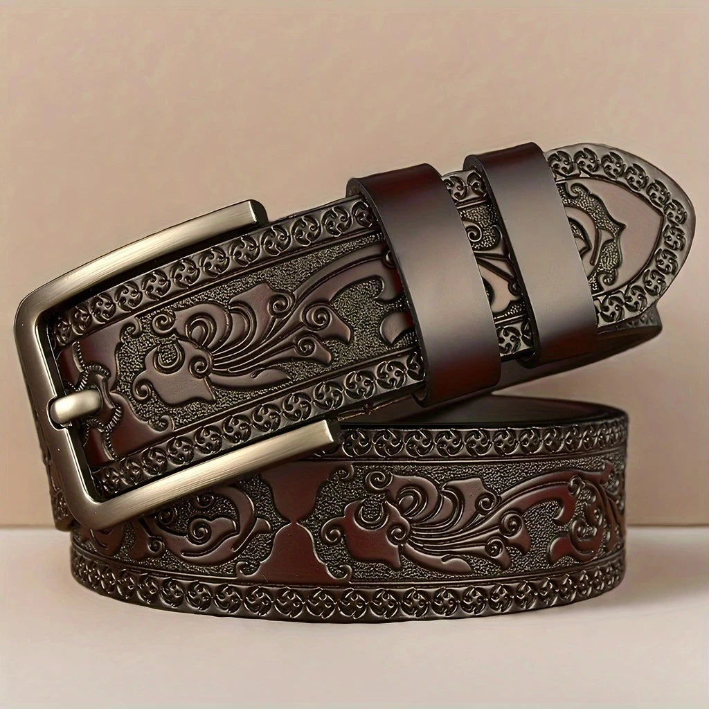 Brown leather belt with intricate design and gold buckle on a beige background. Genuine split leather belt with retro western style and alloy buckle. Durable, stylish unisex belt for casual wear. Fast UK shipping.