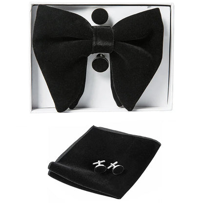 Black bow tie, pocket square, and cufflinks set in a box on a white background