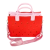 Red handbag with a white strap on a neutral background. Easy-cleaning large EVA tote bag, colourful square-shaped, women's fashion handbag with shoulder strap for bulk and promotional use.