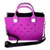 Purple handbag with a black strap on a white background. Easy-cleaning large EVA tote bag, colourful square-shaped, women's fashion handbag with shoulder strap for bulk and promotional use.