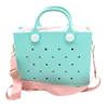 Light blue handbag with pink strap and polka dots on a white background. Easy-cleaning large EVA tote bag, colourful square-shaped, women's fashion handbag with shoulder strap for bulk and promotional use.