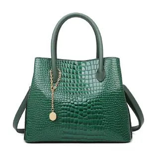 Green handbag with a gold chain detail on a white background. Large capacity portable women’s crossbody bag with soft handle, zipper closure, chain accents, solid color print, perfect for daily fashion.