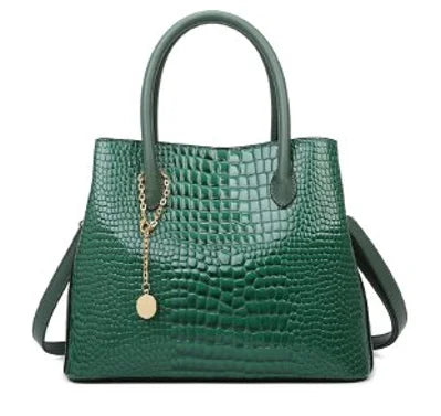 Green handbag with gold chain and clasp on a white background. Large capacity portable women’s crossbody bag with soft handle, zipper closure, chain accents, solid color print, perfect for daily fashion.