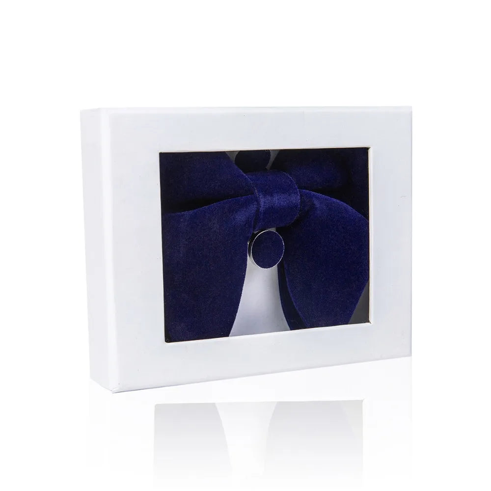 Navy blue bow tie in a white box on a white background