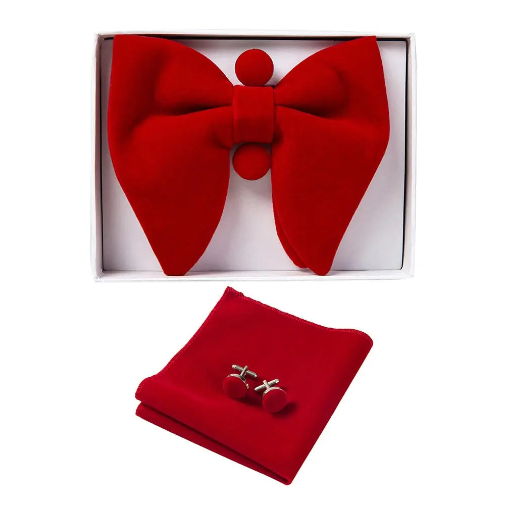 Red bow tie and matching pocket square set with cufflinks in a box on a white background