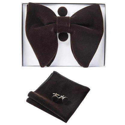 Brown bow tie, pocket square, and cufflinks set in a box on a white background
