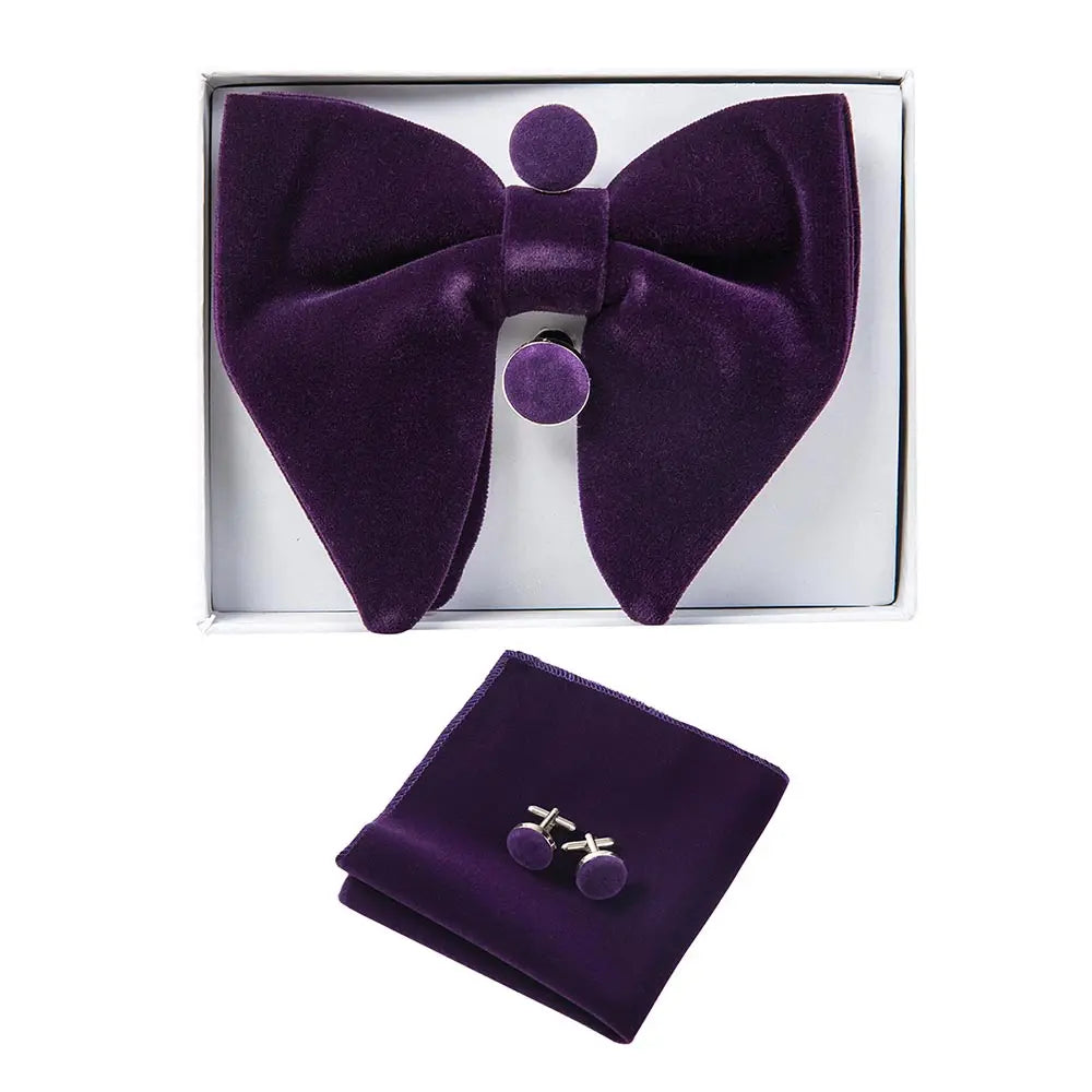 Purple bow tie, pocket square, and cufflinks set in a box on a white background