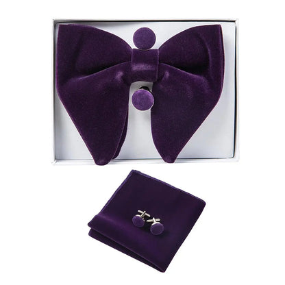 Purple bow tie, pocket square, and cufflinks set in a box on a white background
