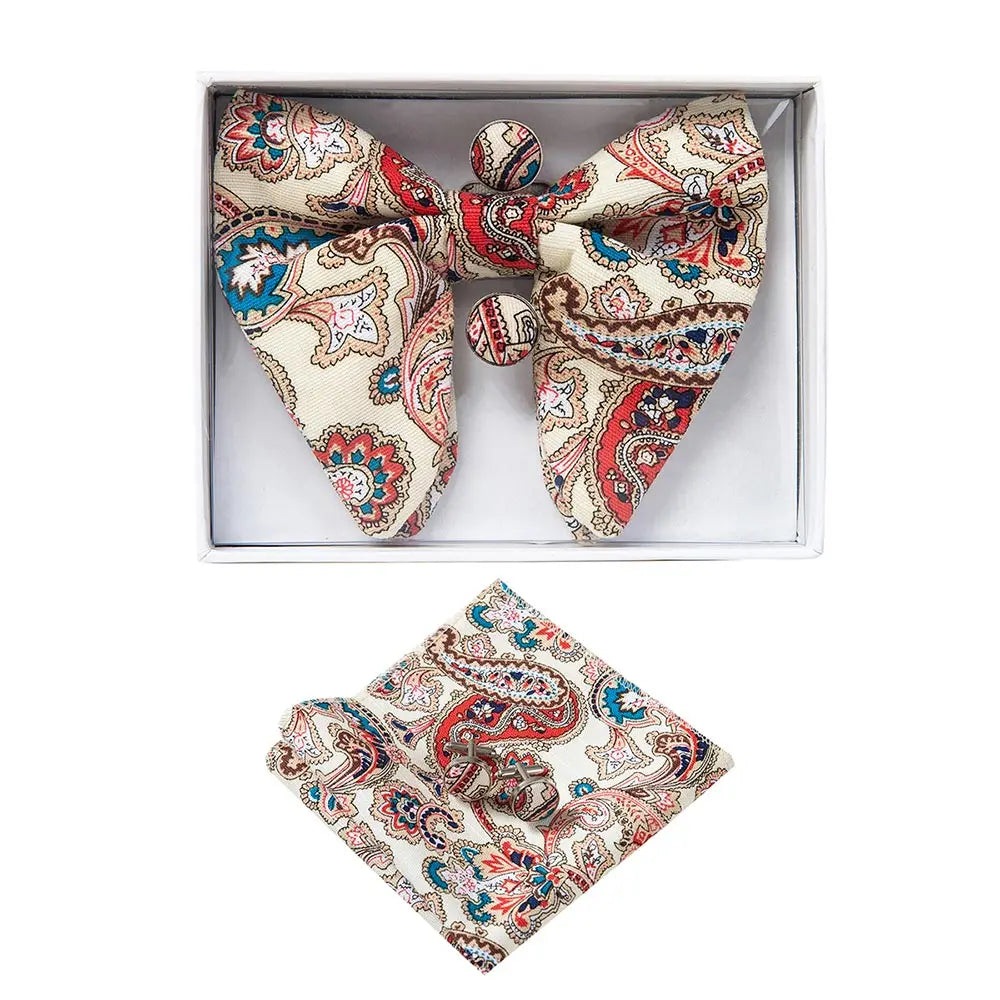 Paisley patterned bow tie and pocket square set in a box on a white background
