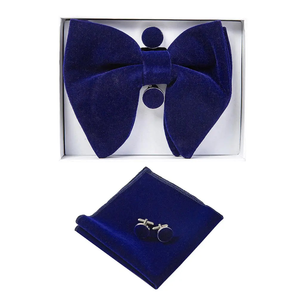 Blue bow tie, pocket square, and cufflinks set in a box on a white background
