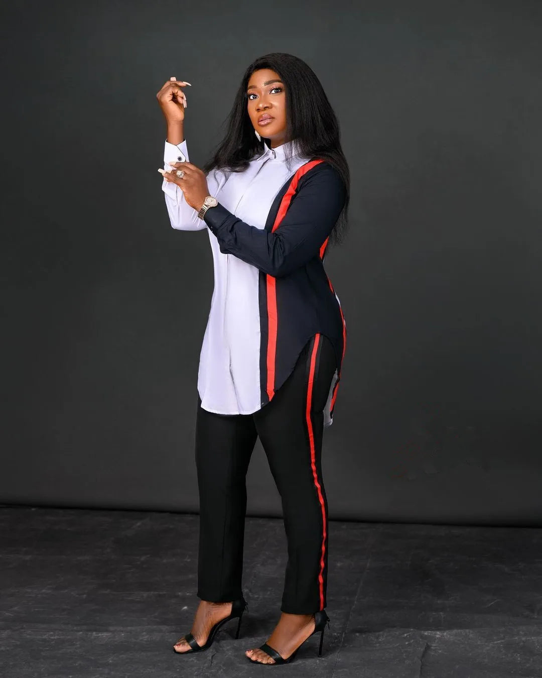 Woman wearing a black and red outfit with a white shirt against a dark background. Women’s stripe print long sleeve blouse and regular high waist pants set. Office lady outfit, comfortable, elegant, solid workwear for spring/autumn.