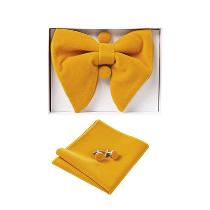 Yellow bow tie, handkerchief, and cufflinks set in a box on a white background