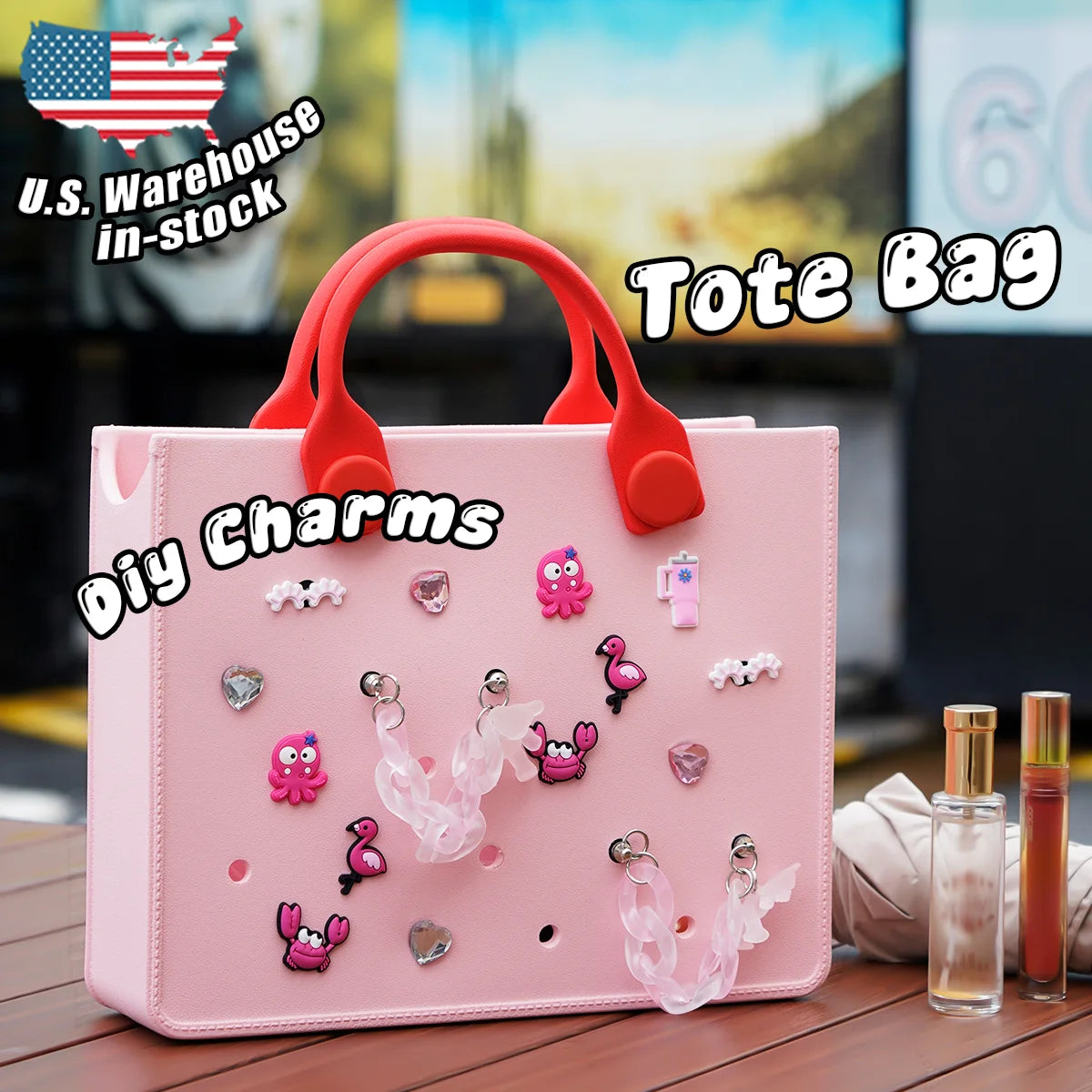 Pink tote bag with red handles and various charms on a wooden surface. Easy-cleaning large EVA tote bag, colourful square-shaped, women's fashion handbag with shoulder strap for bulk and promotional use.