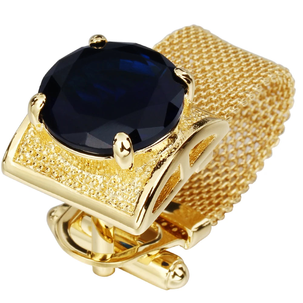 Blue crystal cufflinks with a gold-plated frame, styled for a striking and bold look on a white shirt cuff.