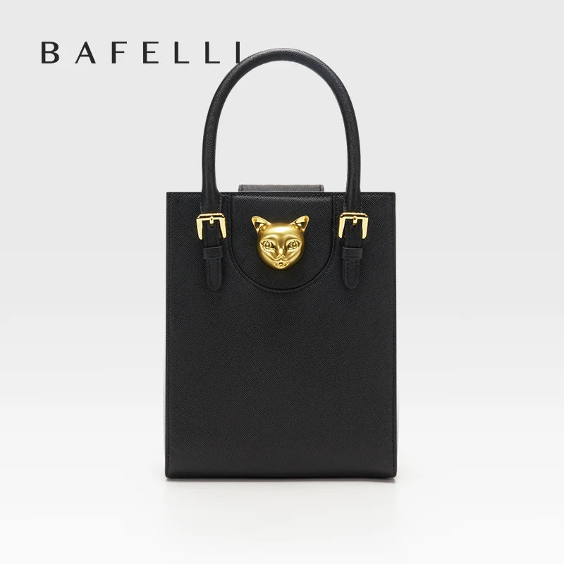 Black handbag with gold accents featuring a cat face design on a white background, branded 'Bafelli'. Unisex mini tote crossbody bag in split leather with flap pocket and lock closure. Hard box shape and polyester lining. Casual versatile style.
