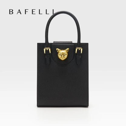 Black handbag with gold accents featuring a cat face design on a white background, branded 'Bafelli'. Unisex mini tote crossbody bag in split leather with flap pocket and lock closure. Hard box shape and polyester lining. Casual versatile style.