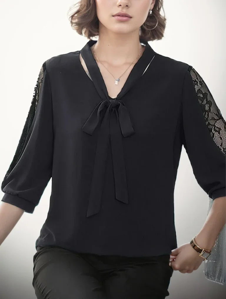 Black blouse with lace sleeves worn by a person on a white background