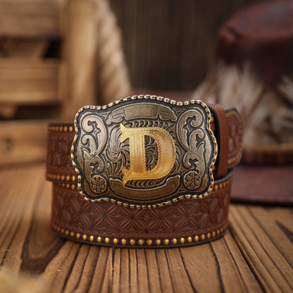 Brown leather belt with a decorative buckle featuring the letter 'D' on a wooden surface.