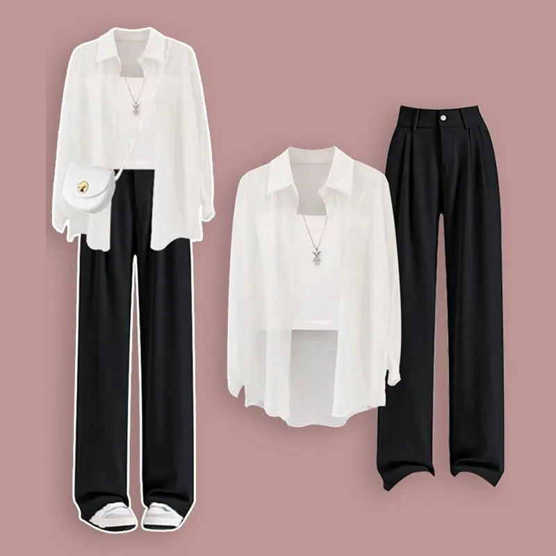 White blouse with black pants on a pink background. Women’s 3-piece French style set: chiffon cardigan, sling shirt, high-waist wide leg pants. Chic, lightweight and sun-protective fashion for spring/summer.