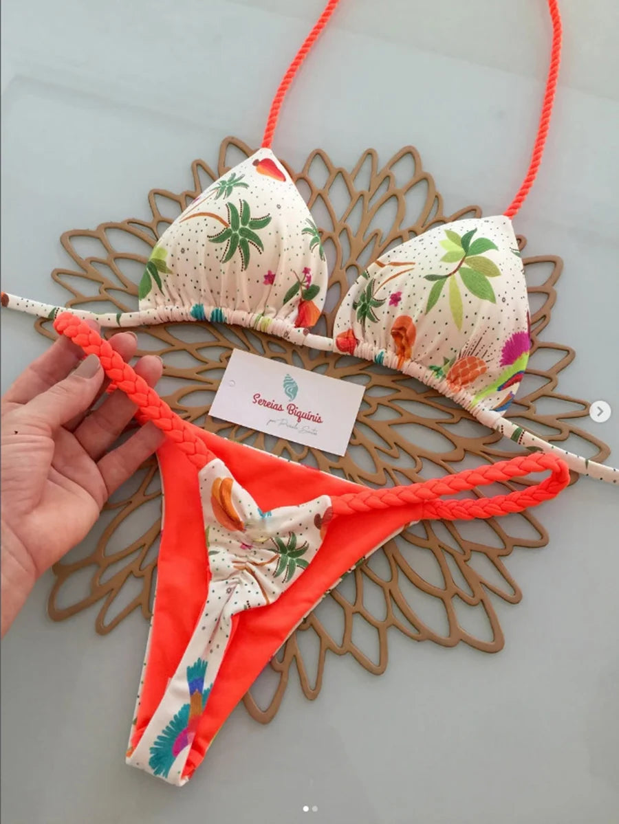 Floral bikini set with orange accents on a decorative mat