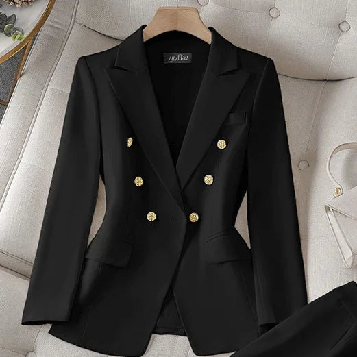 Black blazer with gold buttons on a hanger against a neutral background