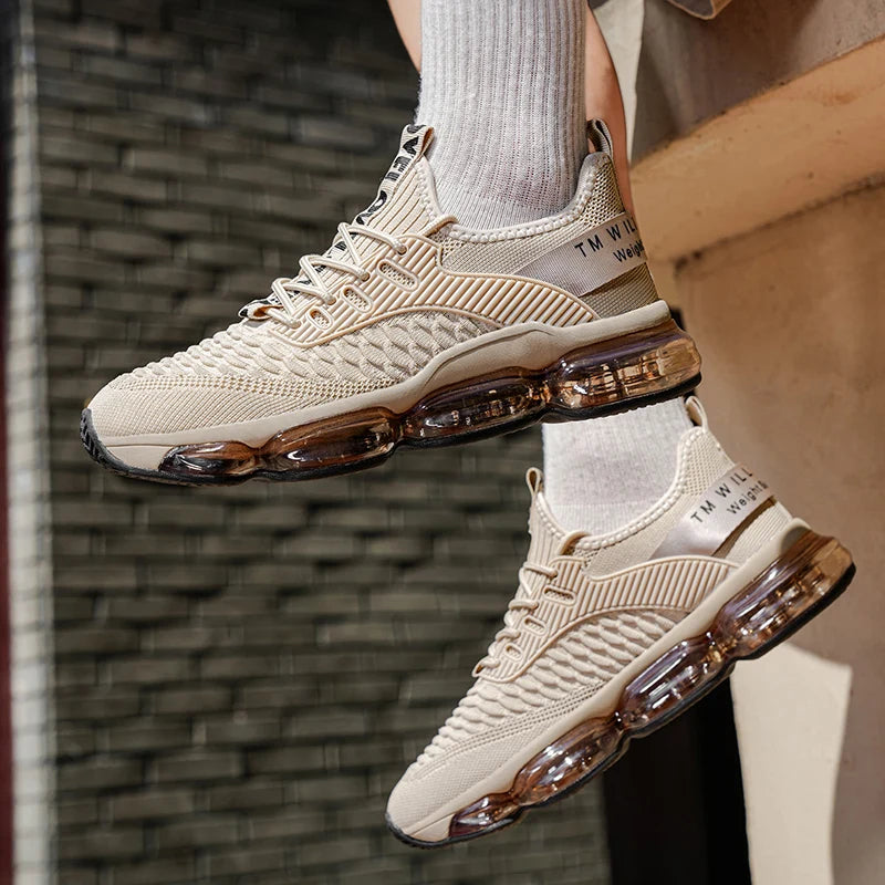 Beige sneakers with transparent air bubbles worn by a person against a brick wall background