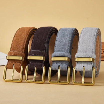 Four belts with gold buckles on a beige background