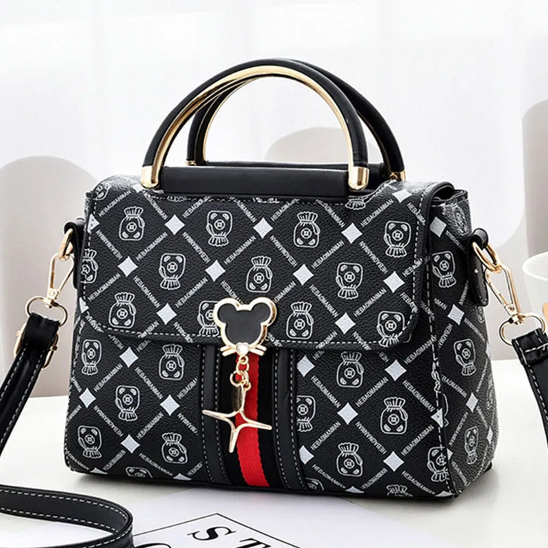 Designer handbag with brand logo and Mickey Mouse charm on a white background