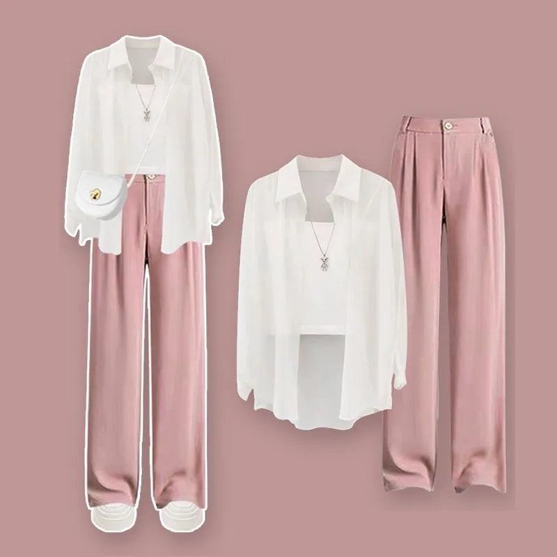 White blouse and pink pants on a pink background. Women’s 3-piece French style set: chiffon cardigan, sling shirt, high-waist wide leg pants. Chic, lightweight and sun-protective fashion for spring/summer.