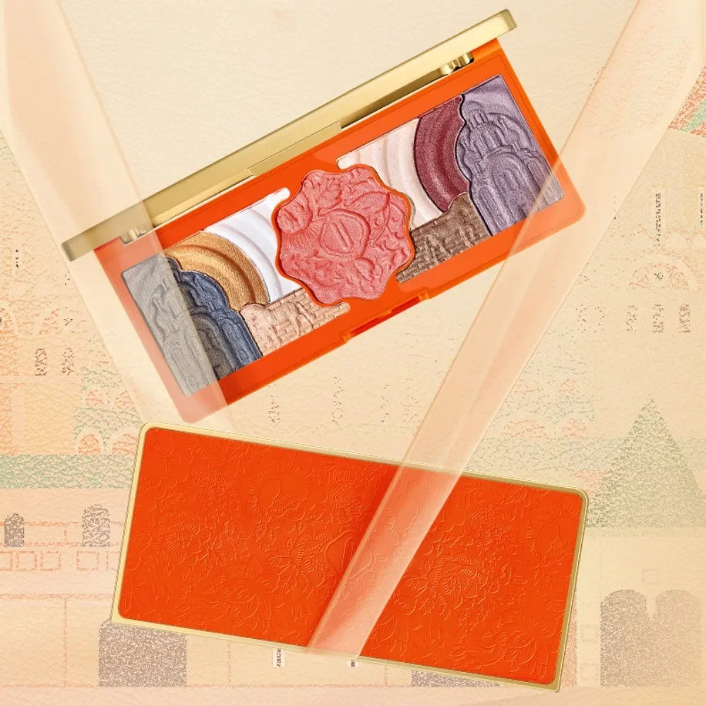 Makeup palette with various shades on a textured beige background. Christmas makeup gift box with BB cream, lipstick, eyeshadow, eyebrow pencil, and brushes. Holiday beauty set for women & girls.