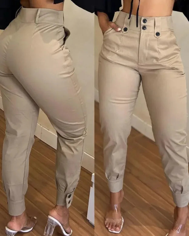 Beige jogger pants worn by a person on a wooden floor.