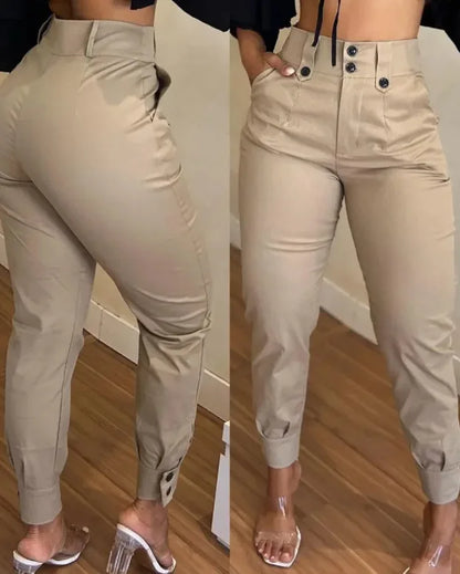 Beige jogger pants worn by a person on a wooden floor.