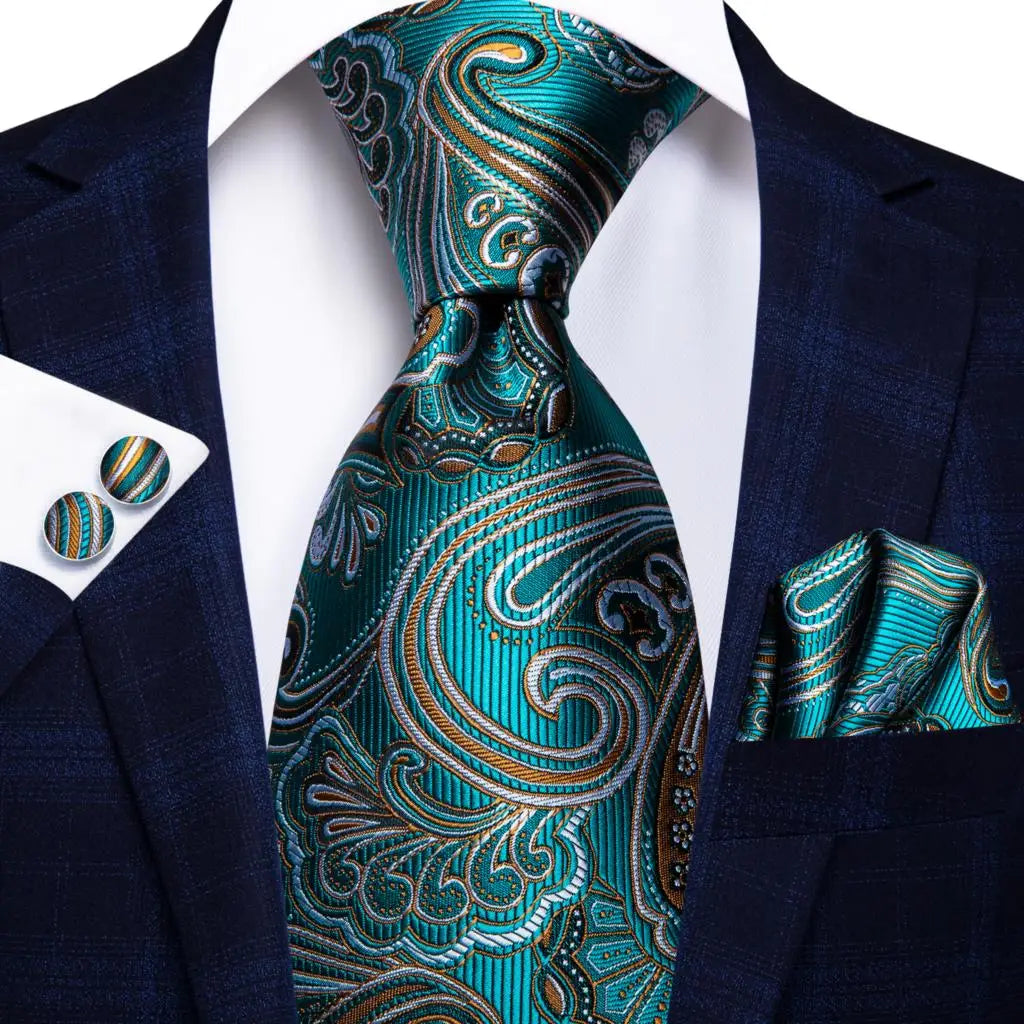 Teal paisley tie set with matching pocket square and cufflinks on a suit jacket. Men’s luxury paisley silk tie and pocket square set, 8.5cm wide, for business or wedding. Red formal necktie, ftf fashion UK.