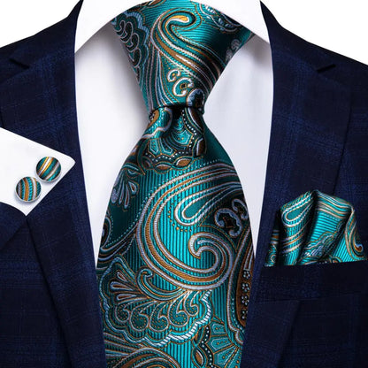 Teal paisley tie set with matching pocket square and cufflinks on a suit jacket. Men’s luxury paisley silk tie and pocket square set, 8.5cm wide, for business or wedding. Red formal necktie, ftf fashion UK.