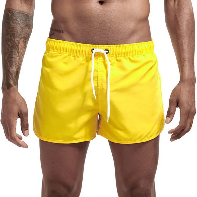 Men's yellow quick-drying swimming trunks in vibrant colors for beach and surfing