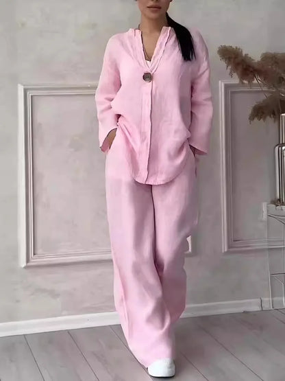 Women's 2-piece linen set in pink — relaxed fit V-neck top and wide leg trousers...