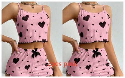 Pink two-piece set with heart patterns on a plain background. Soft women’s pajama set, 2 pieces white tank top and shorts, breathable fabric with love print, comfortable casual sleepwear, UK FTF Market.