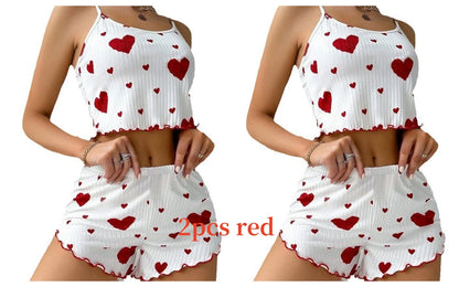 White top and shorts set with red heart patterns on a white background. Soft women’s pajama set, 2 pieces white tank top and shorts, breathable fabric with love print, comfortable casual sleepwear, UK FTF Market.