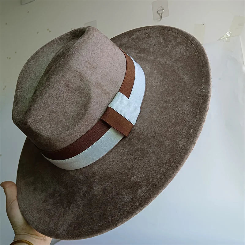 Brown suede hat with a brown and white band on a light gray background