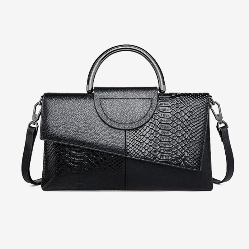 Black handbag with snake skin pattern on a white background