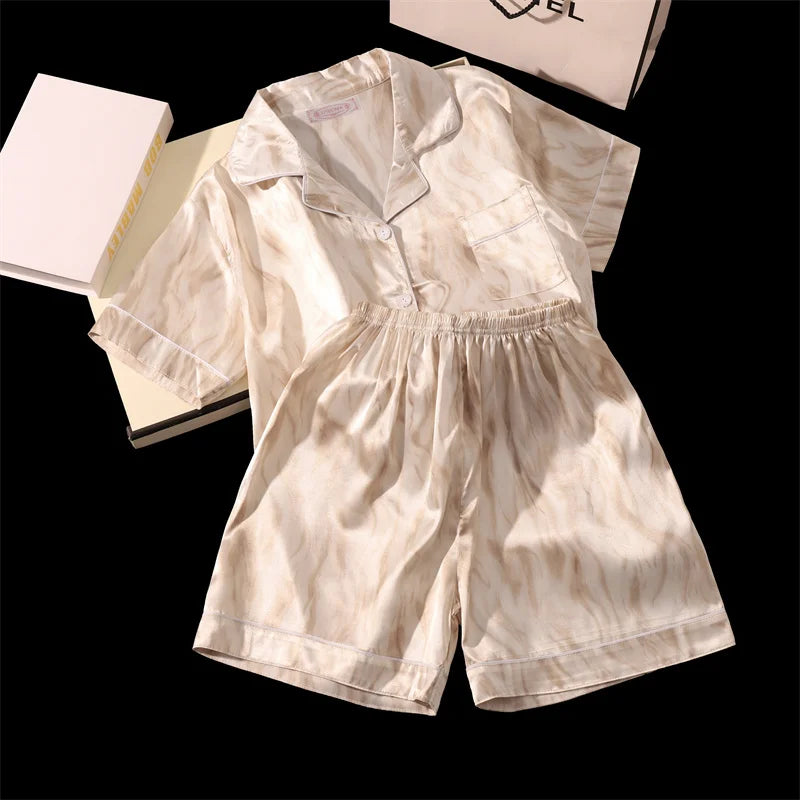 Beige romper with a shirt and shorts on a black background. Women’s cherries print summer pajamas set—faux satin V-neck top and shorts, funny cute style. Lightweight, comfortable, UK fashion set.