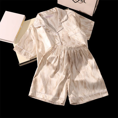 Beige romper with a shirt and shorts on a black background. Women’s cherries print summer pajamas set—faux satin V-neck top and shorts, funny cute style. Lightweight, comfortable, UK fashion set.